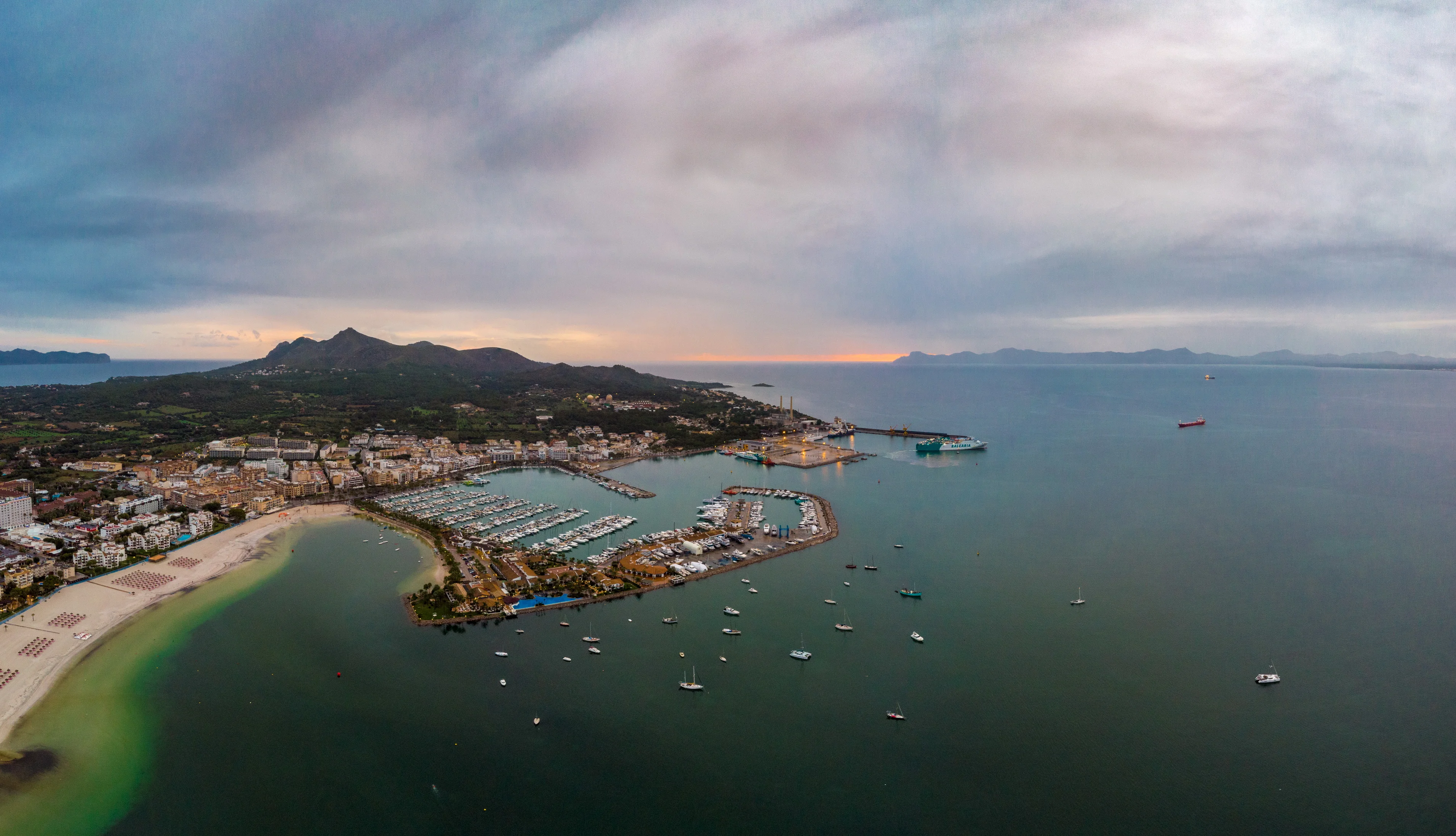 Yachts and motorboats moored in Port d'Alcudia marina on a clear summer morning